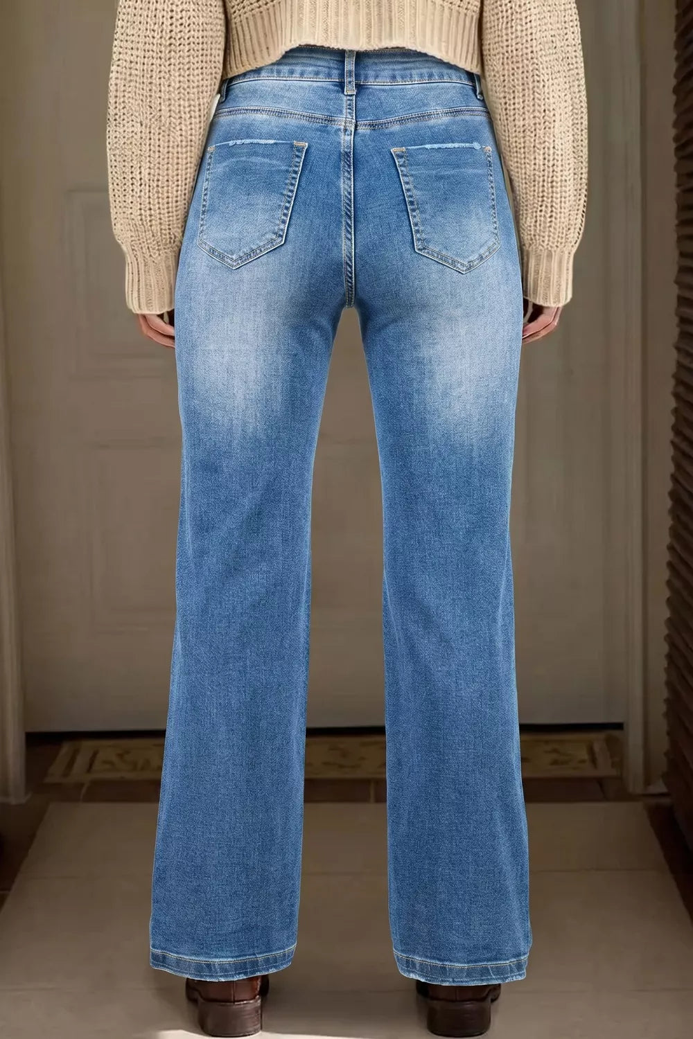 Acid-washed denim straight-leg jeans with distressed pockets and frayed hem