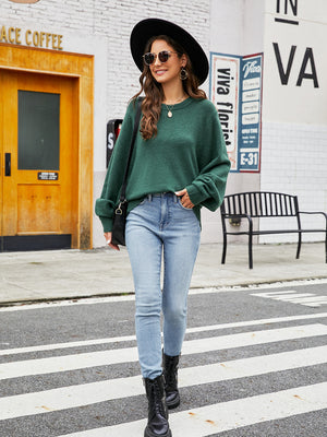 Green acrylic crewneck sweater with balloon sleeves, styled with light wash jeans.