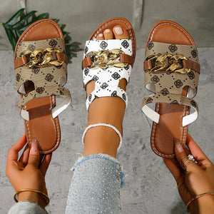 Patterned slide sandals with chain accent in apricot and gray/white.