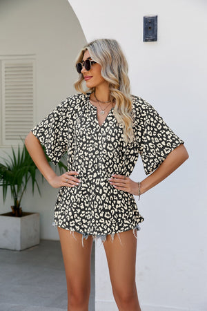 Black leopard print v-neck blouse with short sleeves and a relaxed fit.