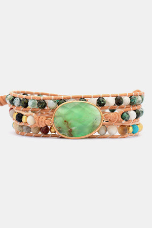 Wrap-around bracelet with light green gemstone and mixed bead details on leather cords