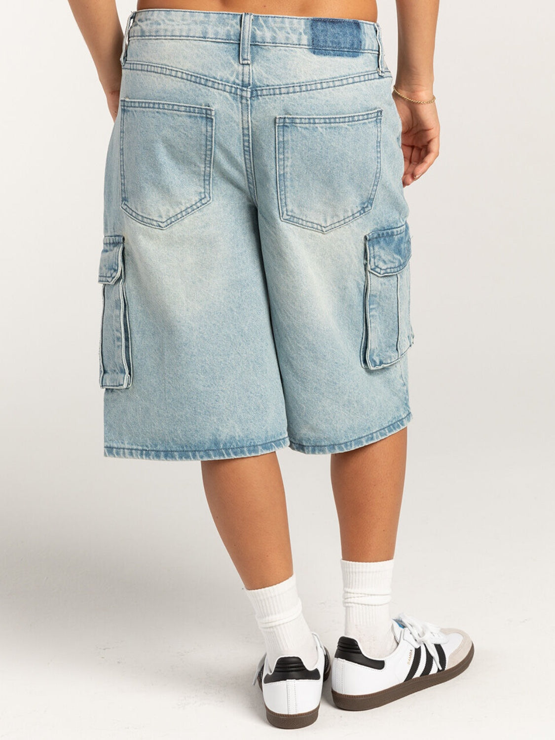 Light blue denim cargo bermuda shorts with buttoned pockets and a relaxed fit.