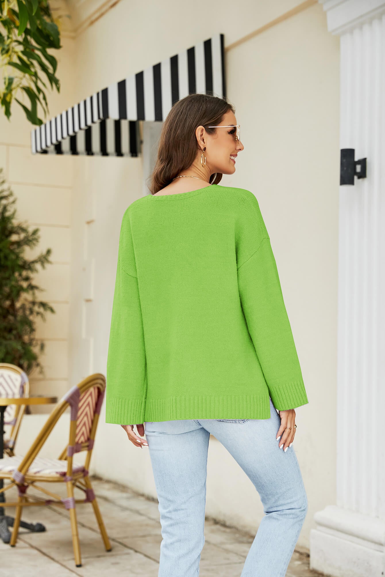 Relaxed fit V-neck knit pullover sweater in bright yellow-green with long sleeves and ribbed cuffs.