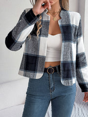 Collarless plaid cropped jacket in dark blue and white, open front, long sleeves.