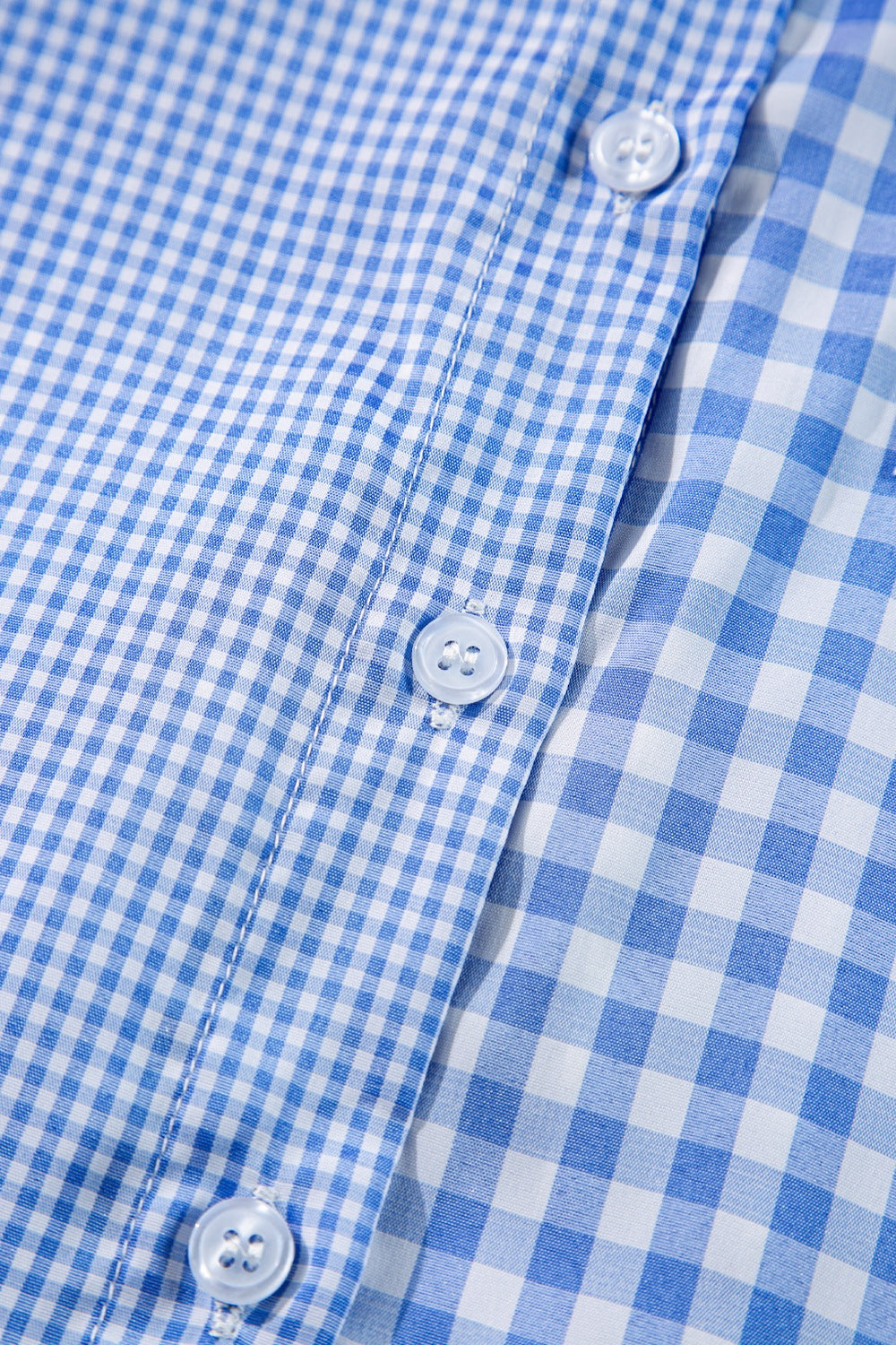 Light blue gingham oversized shirt with patch pocket detail and buttons.