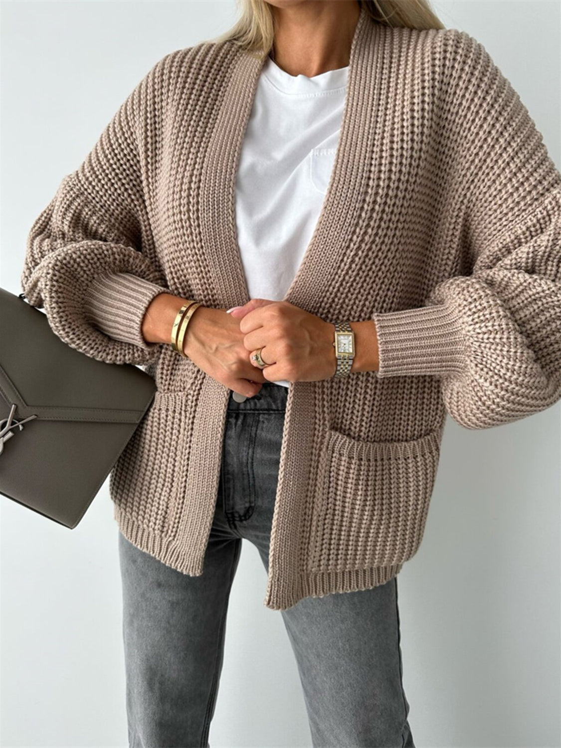 Beige textured puff sleeve cardigan with pockets, styled with a white tee and grey jeans.