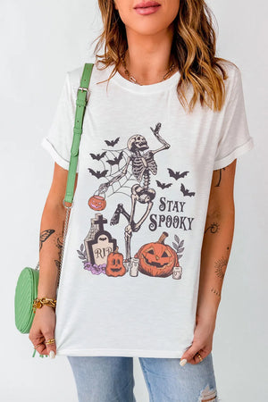 White graphic t-shirt with skeleton, bats, pumpkins, and RIP tombstone, "Stay Spooky" text.