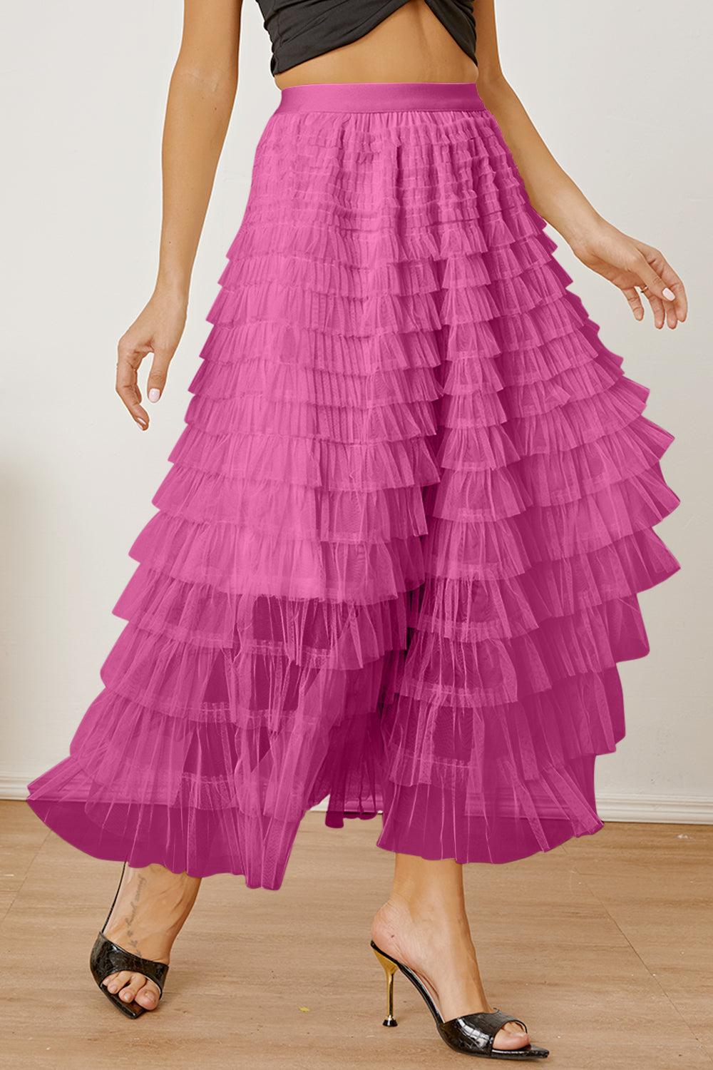 Tiered tulle maxi skirt in pink with ruffled layers and a flowy silhouette.
