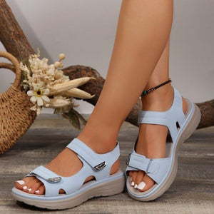 Sky blue adjustable open-toe sandals with contrast stitching and buckle detail.