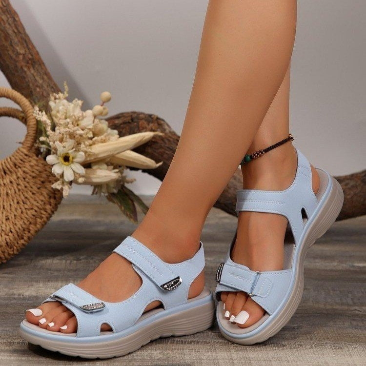 Sky blue adjustable open-toe sandals with contrast stitching and buckle detail.