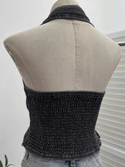 Gathered denim halter top with collar in black, featuring a smocked bodice and button-down detail.