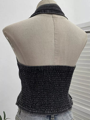 Gathered denim halter top with collar in black, featuring a smocked bodice and button-down detail.