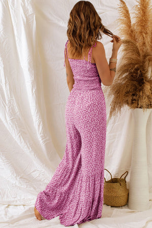 Smocked bodice floral jumpsuit in hot pink with tie straps and flare legs.