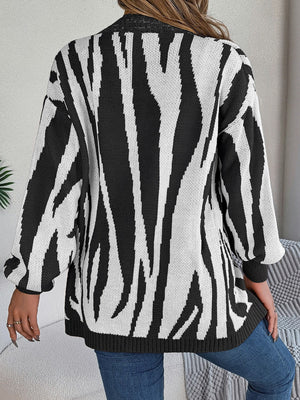 Black and white zebra stripe open-front knit cardigan with long sleeves.