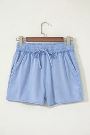 Light blue acid-washed cotton drawstring shorts with pockets and raw hem