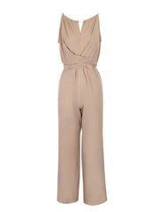 Beige halter neck wide leg jumpsuit with wrap waist detail and drawstring.