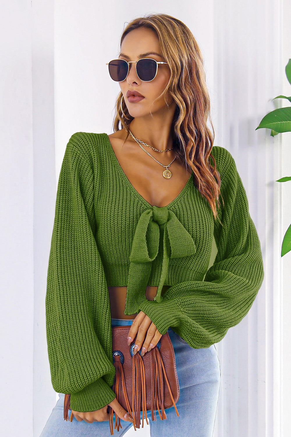 Green acrylic tie-front balloon sleeve crop knit sweater with V-neck.