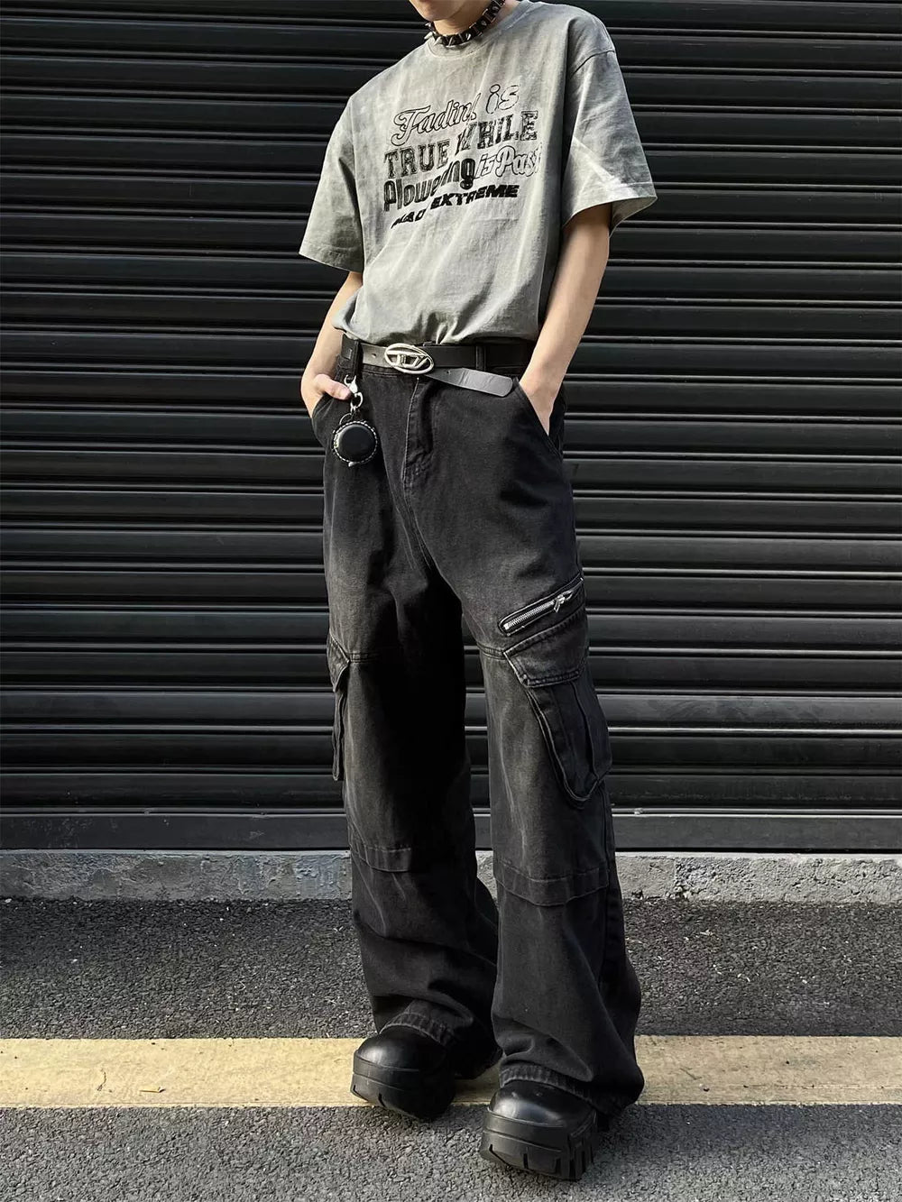 Men's oversized vintage black denim cargo pants with multiple pockets and a belted waist.
