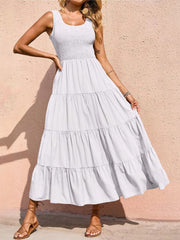 White smocked bodice ruffled maxi dress with tiered skirt and square neckline.