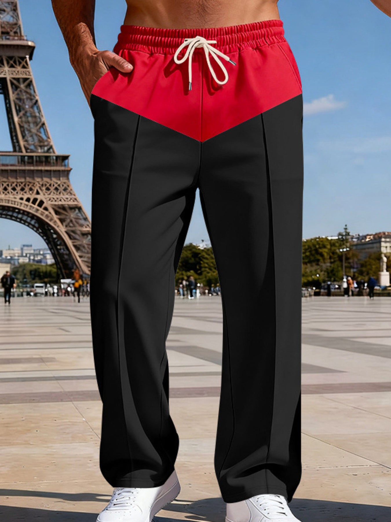 Two-tone relaxed fit men's sweatpants in black with a red chevron yoke and drawstring waist.