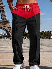 Two-tone relaxed fit men's sweatpants in black with a red chevron yoke and drawstring waist.