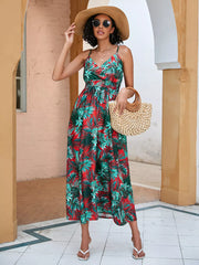 Chic floral midi dress with spaghetti straps in red and green tropical print.