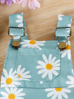 Baby overalls in picture color with adjustable straps and daisy print.