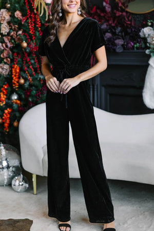 Black velvet wrap bodice jumpsuit with wide legs and drawstring waist.