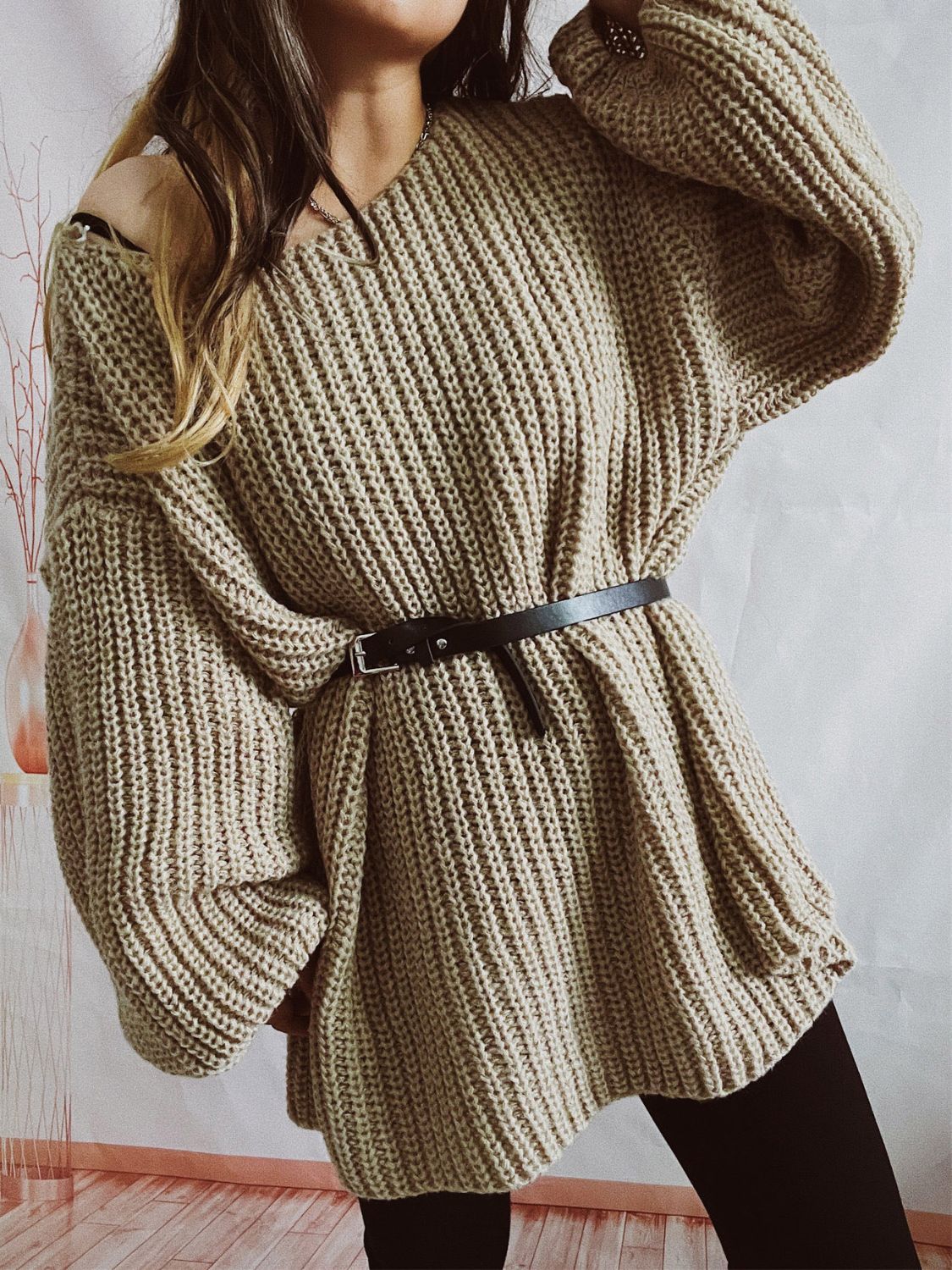 Beige oversized ribbed knit sweater with belted waist and V-neck.