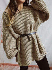 Beige oversized ribbed knit sweater with belted waist and V-neck.