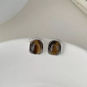 Silver square stud earrings with polished tiger eye gemstone centers