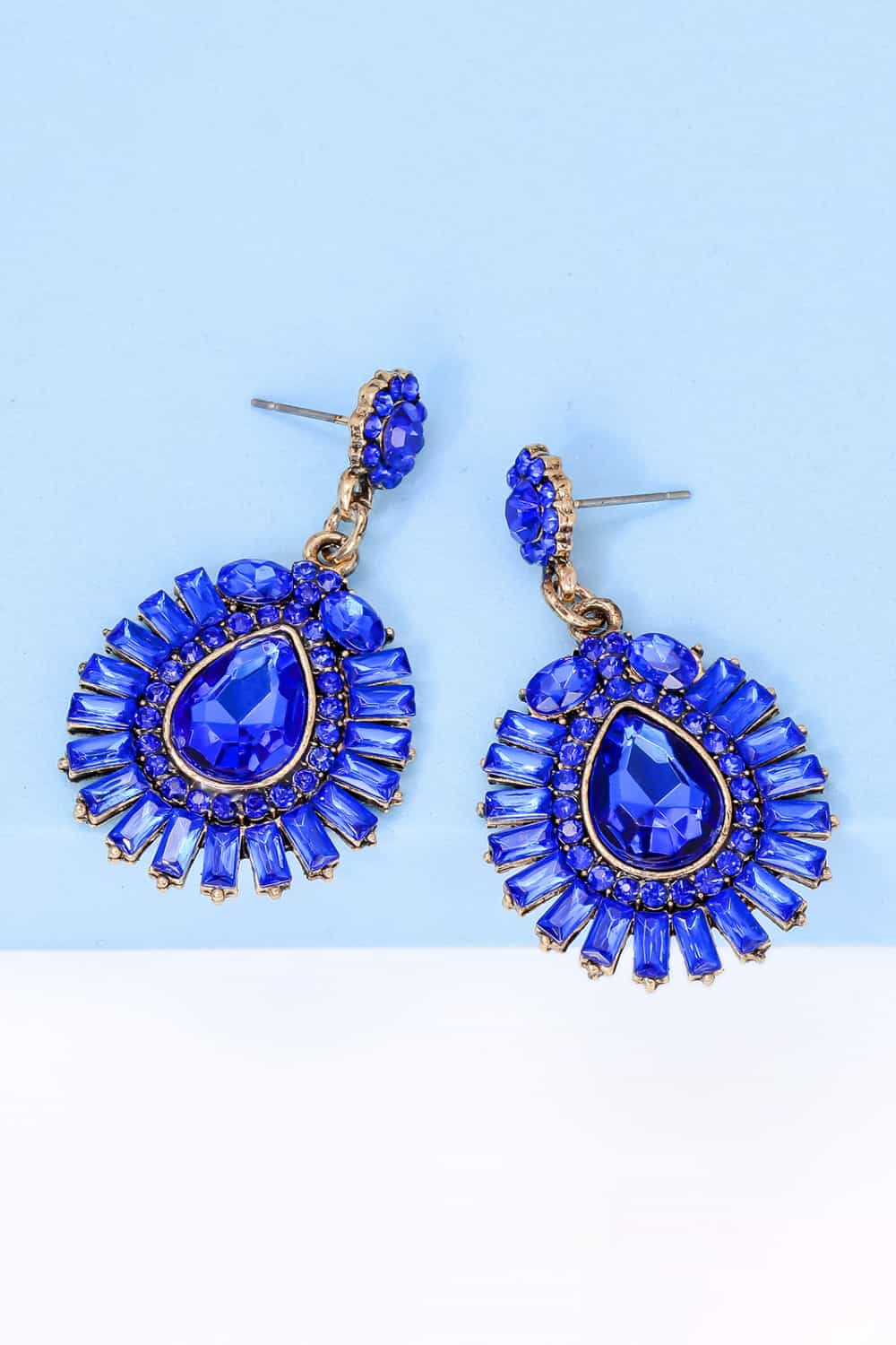Royal blue gemstone burst dangle earrings with gold-tone metal.