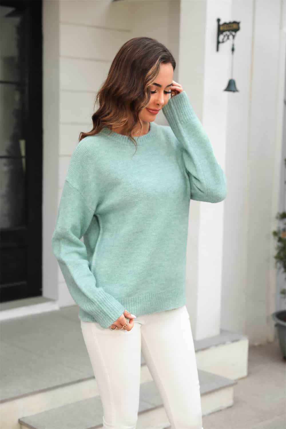 Light Green brushed-knit crewneck pullover sweater with long sleeves.