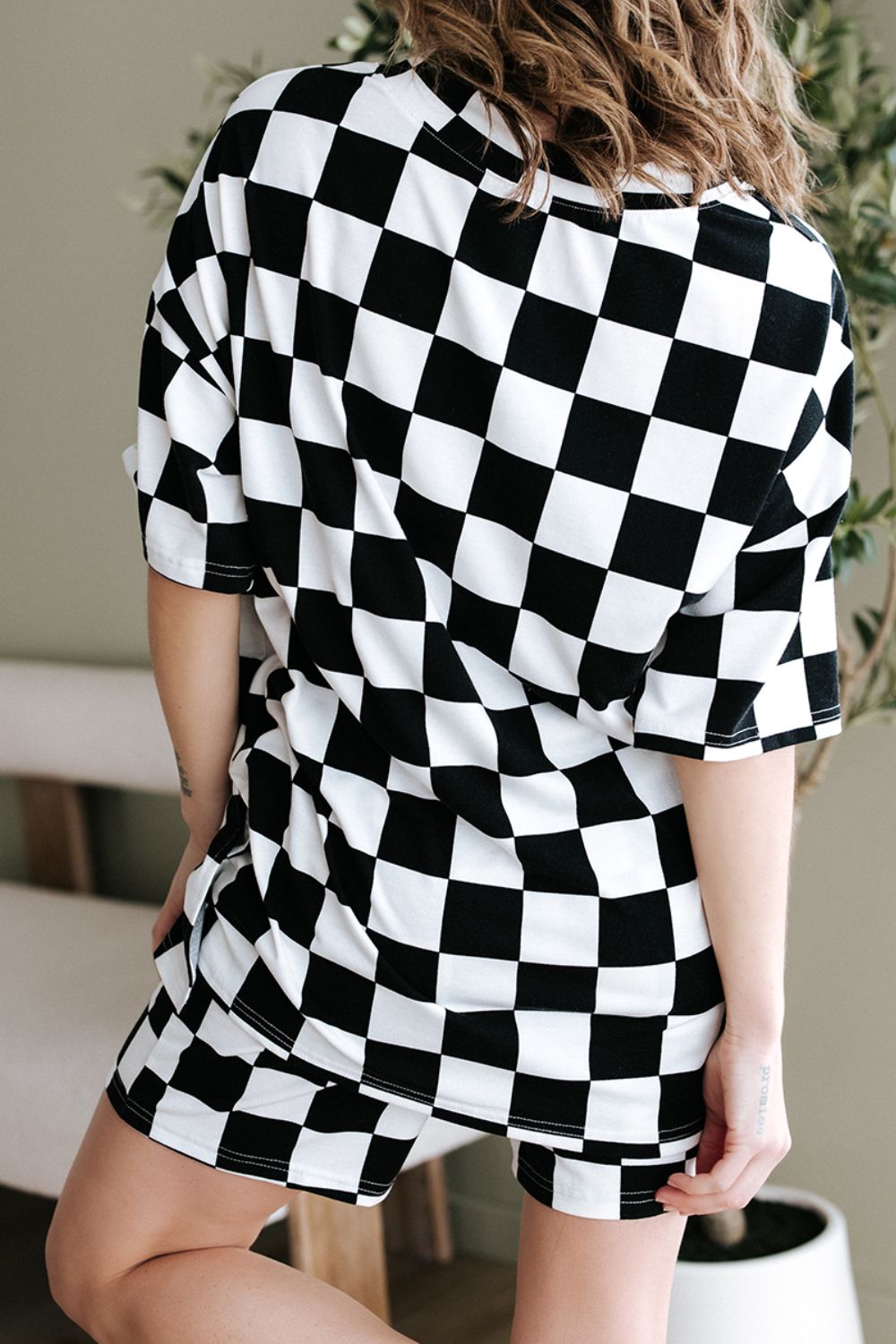 Black and white checkered outfit set with oversized t-shirt and shorts.