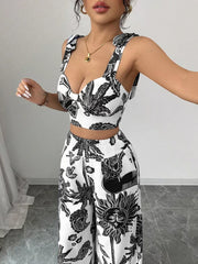Black and white tropical print crop top with tie straps and wide-leg pants set.