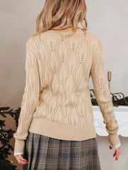 Pearl-adorned V-neck knit sweater in beige with cable knit detail and scalloped lace cuffs.
