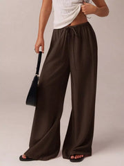 Brown maternity pants with drawstring and wide legs.