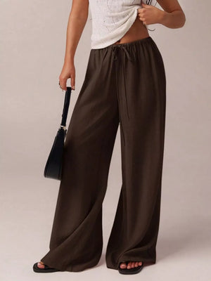 Brown maternity pants with drawstring and wide legs.