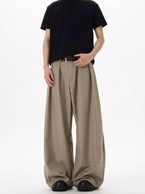 Men's khaki relaxed fit sweatpants with pleats and a wide leg.
