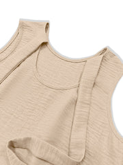 Beige backless mini dress with textured fabric and ruffled hem detail.