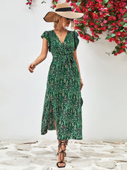 Green floral wrap midi dress with flutter sleeves and belted waist