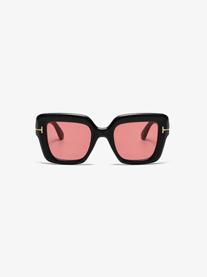 Black acetate geometric sunglasses with pink tinted lenses and gold accents.