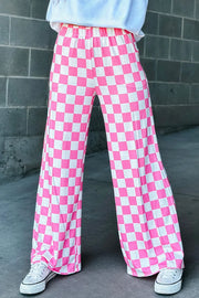 Checkerboard palazzo trousers in fuchsia pink and white, with a wide leg and elastic waist.