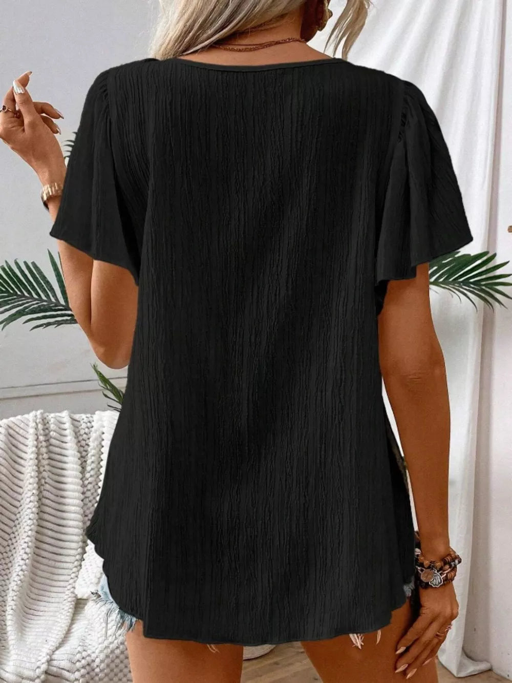 Black embroidered square neck flutter blouse with textured fabric and short sleeves.