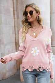 Pink knit sweater with daisy appliques, distressed hem, and V-neck.