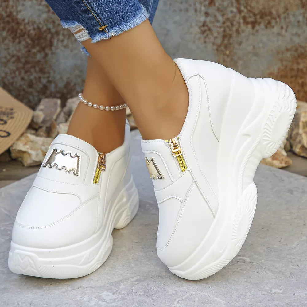 White round toe platform sneakers with gold zipper detail and stacked sole.
