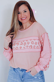 Blush pink waffle knit top with leopard print panels and balloon sleeves.