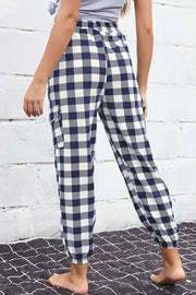 Gingham cargo joggers with elastic waist and pockets in navy and white.