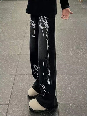 Men's black wide-leg jeans with graffiti print and stars detail.