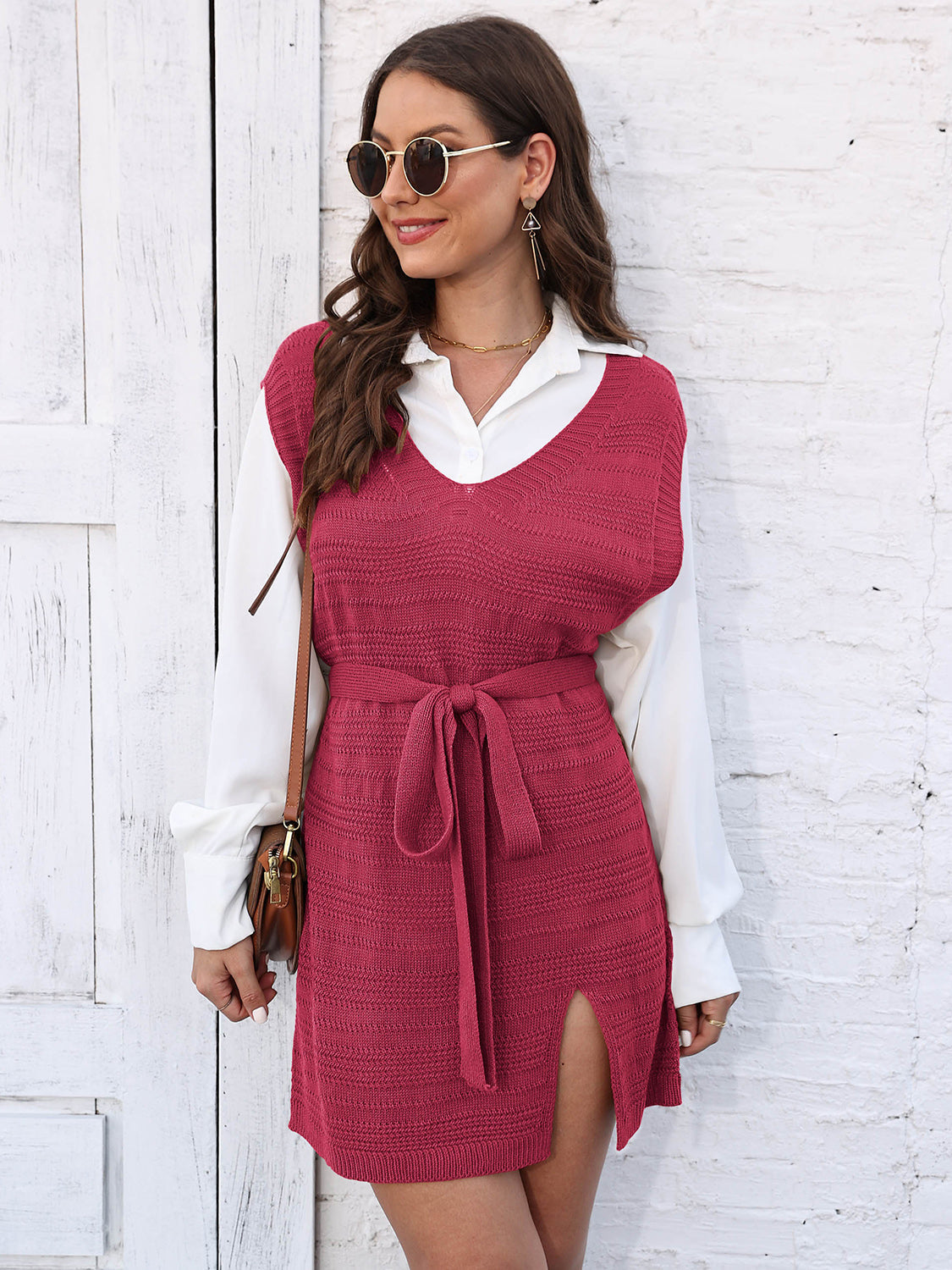 Deep Red knit vest dress with V-neck, tie waist, and side slit, worn over a white shirt.